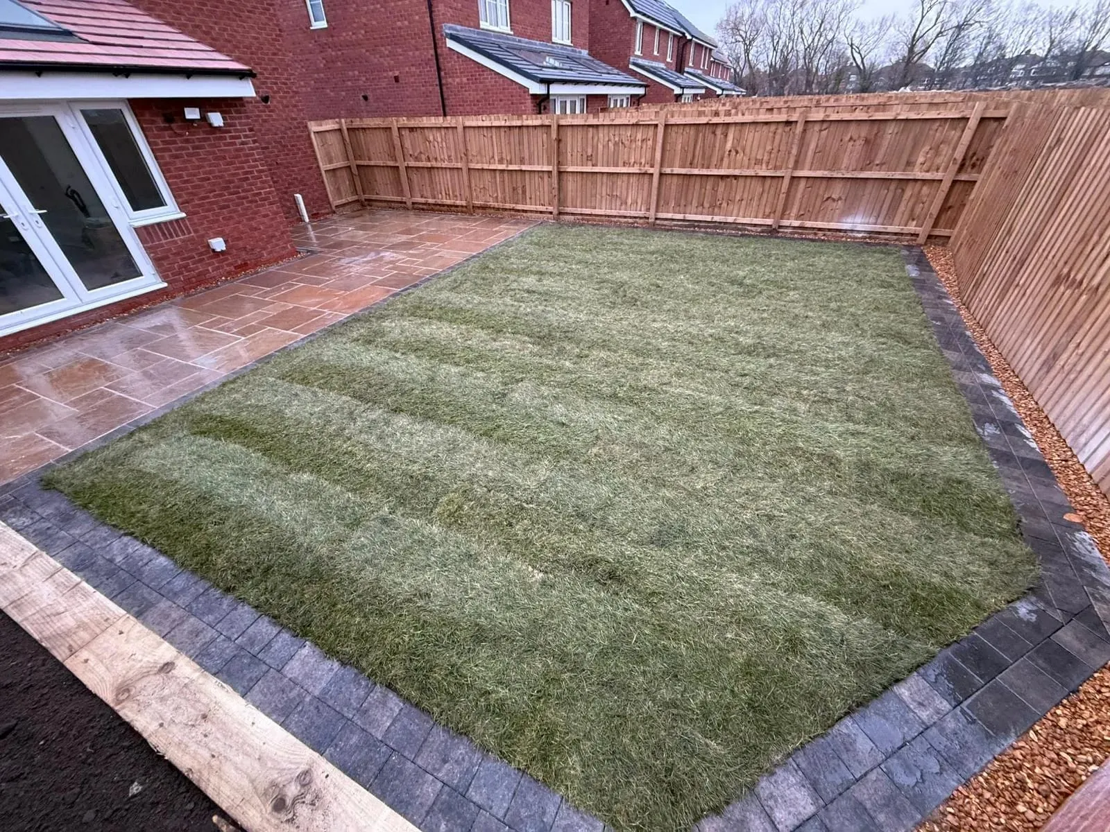 Artificial lawn with a block paving border