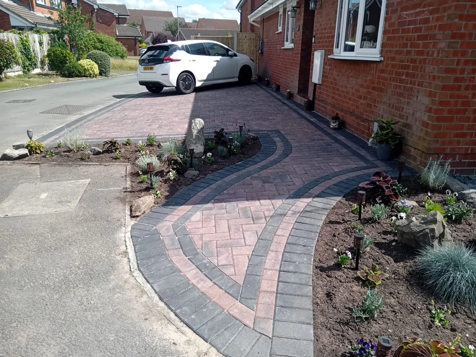 Block paving laid with a curved edging border