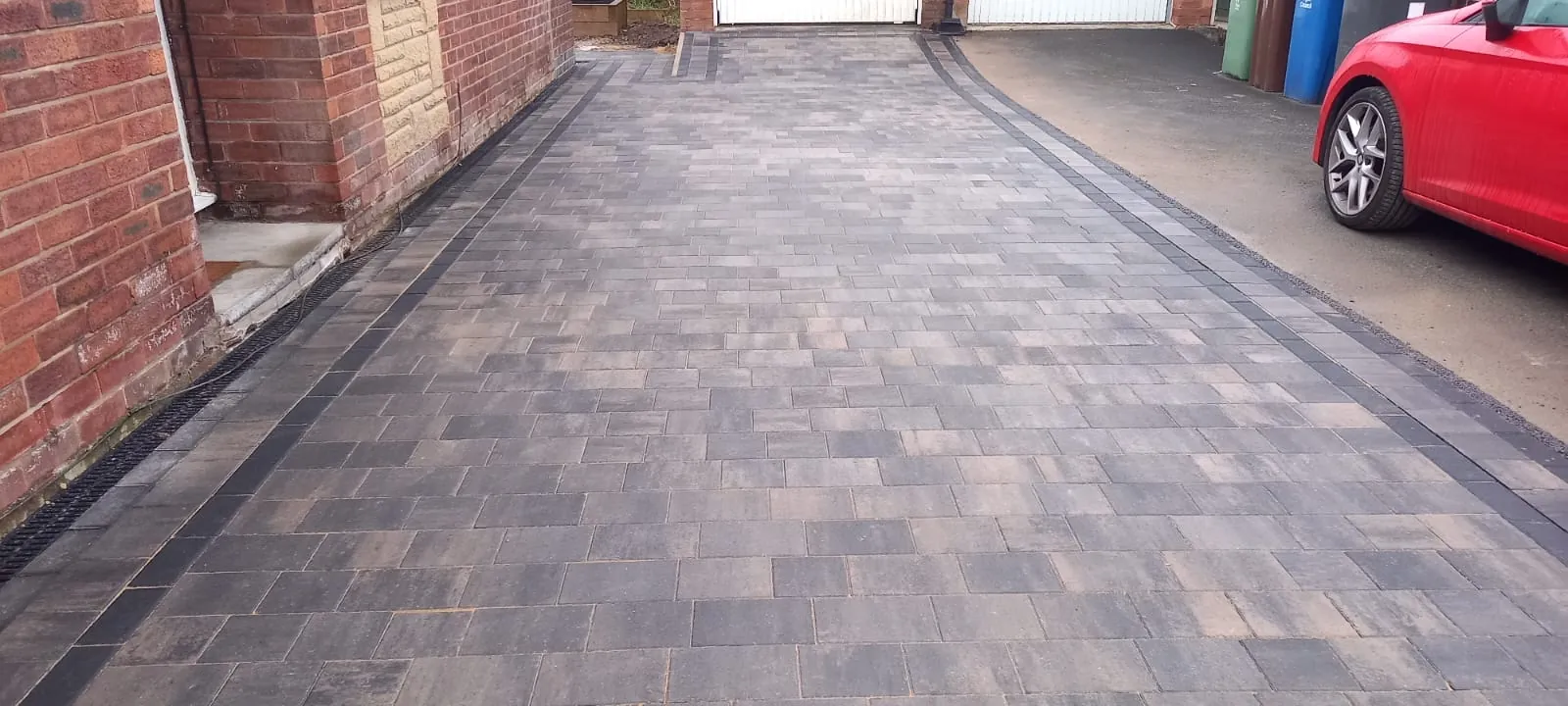 Block paved side path running beside a house